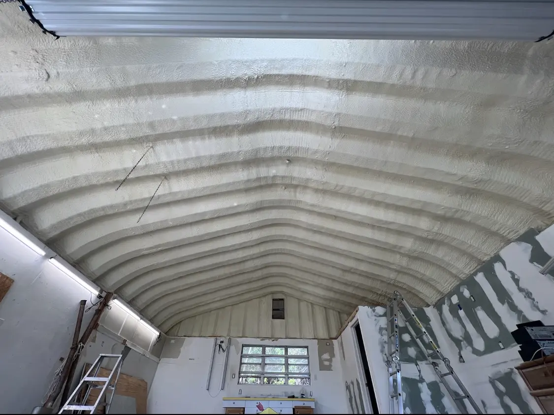 Spray polyurethane foam applied to the underside of a metal roof deck in Great Falls